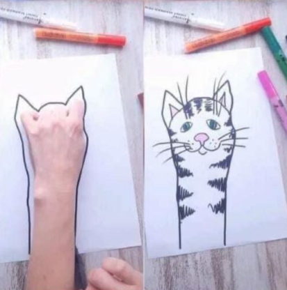 cat drawn by drawing around the hand on the paper