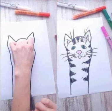 cat drawn by drawing around the hand on the paper